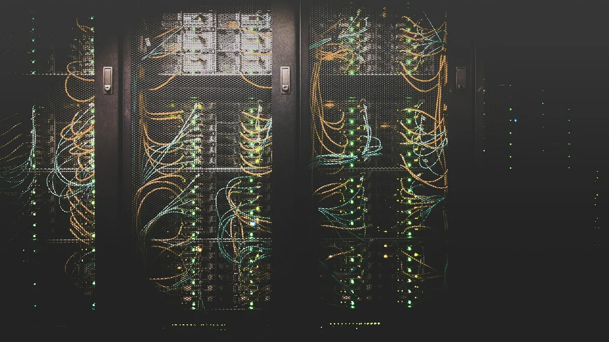Server racks, network cables, and status lights inside a data center